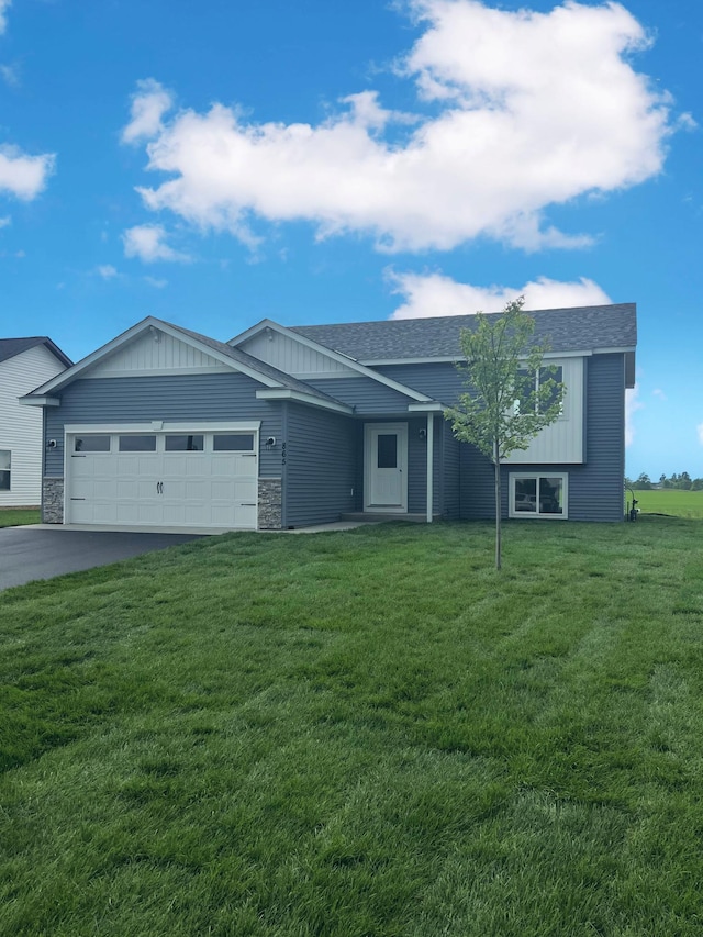 935 2 1/2 Ave, Rice, MN 56367 - ranch-style house with a garage, asphalt driveway, stone siding, a front lawn, and a shingled roof