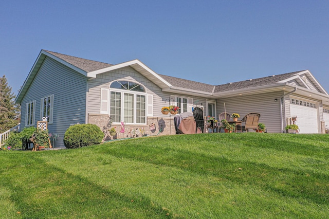 913 Anderson Way, Alexandria, MN 56308 - back of property featuring a garage, a yard, and roof with shingles
