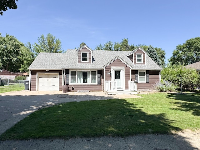 422 Galena St, Worthington, MN 56187 - cape cod home with an attached garage, concrete driveway, and a shingled roof