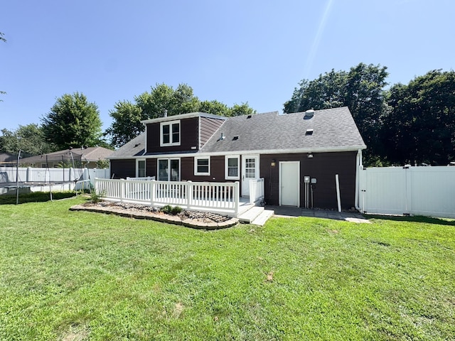 422 Galena St, Worthington, MN 56187 - back of property featuring a trampoline, a fenced backyard, and a wooden deck