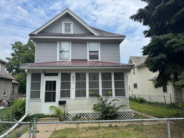1051 Mclean Ave, Saint Paul, MN 55106 - traditional style home featuring a sunroom and a metal roof