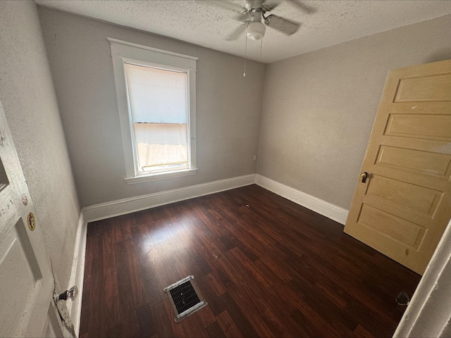 1051 Mclean Ave, Saint Paul, MN 55106 - unfurnished room with a ceiling fan, dark wood-style flooring, and a textured ceiling