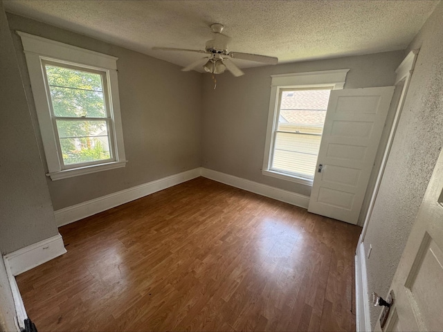 1051 Mclean Ave, Saint Paul, MN 55106 - unfurnished room featuring a textured ceiling, wood finished floors, and ceiling fan