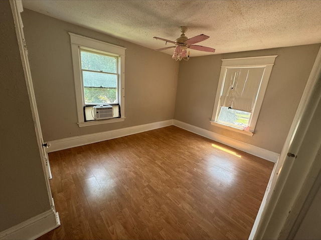 1051 Mclean Ave, Saint Paul, MN 55106 - spare room with wood finished floors, a textured ceiling, a ceiling fan, and cooling unit
