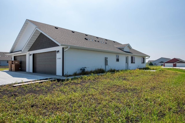 3101 Scotch Ln, Mankato, MN 56001 - view of home's exterior with a garage, driveway, and roof with shingles