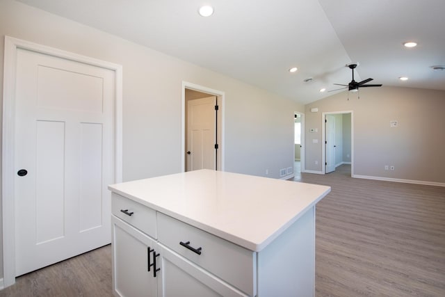 3101 Scotch Ln, Mankato, MN 56001 - kitchen featuring ceiling fan, light wood-style flooring, vaulted ceiling, a center island, and light countertops