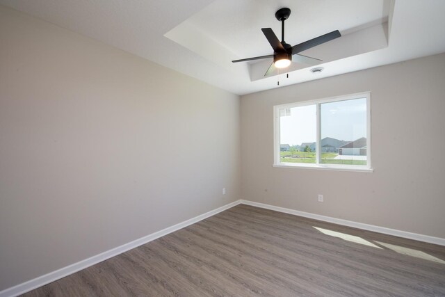 3101 Scotch Ln, Mankato, MN 56001 - empty room featuring wood finished floors, ceiling fan, and a tray ceiling