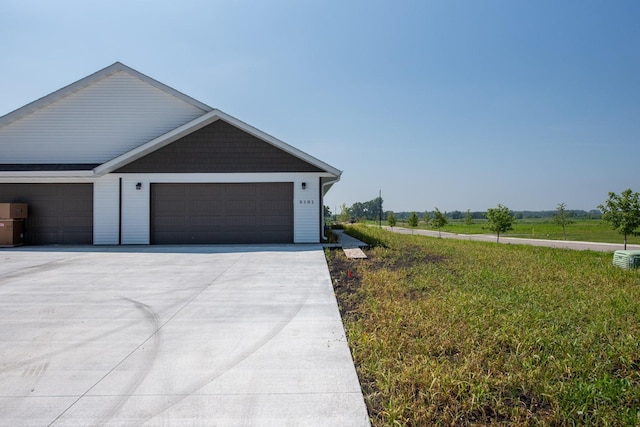 3101 Scotch Ln, Mankato, MN 56001 - view of property exterior featuring concrete driveway, a lawn, and a garage