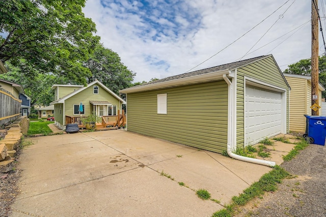 1076 Wilson Ave, Saint Paul, MN 55106 - view of property exterior featuring a garage, a wooden deck, and an outbuilding