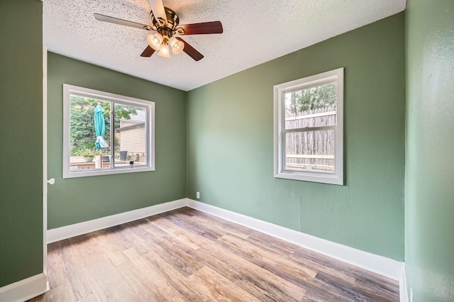 1076 Wilson Ave, Saint Paul, MN 55106 - empty room featuring wood finished floors, a textured ceiling, and a ceiling fan