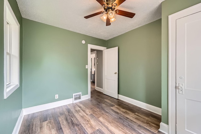 1076 Wilson Ave, Saint Paul, MN 55106 - unfurnished bedroom featuring wood finished floors, a textured ceiling, and a ceiling fan