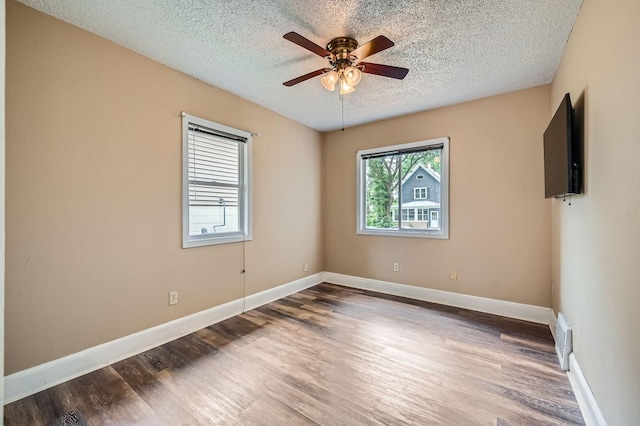 1076 Wilson Ave, Saint Paul, MN 55106 - empty room with wood finished floors, a textured ceiling, and ceiling fan