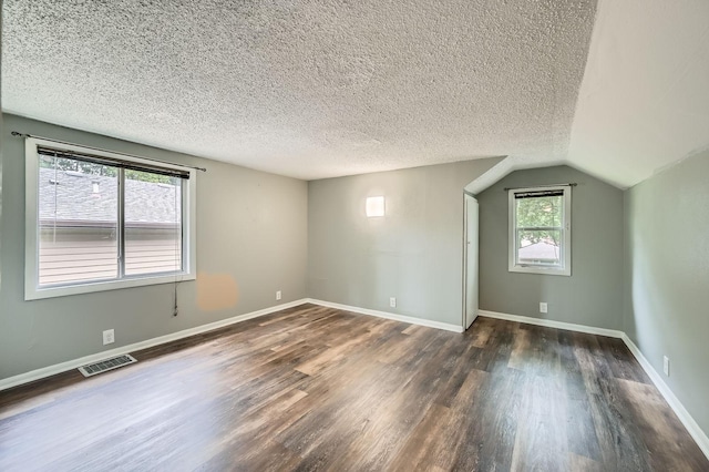 1076 Wilson Ave, Saint Paul, MN 55106 - bonus room with wood finished floors, a textured ceiling, and vaulted ceiling