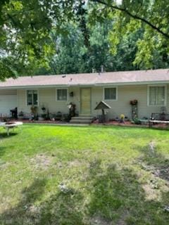10178 Uplander St NW, Coon Rapids, MN 55433 - rear view of house with a garage and a lawn