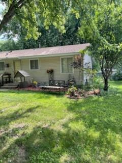 10178 Uplander St NW, Coon Rapids, MN 55433 - rear view of property with a yard