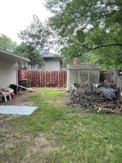 10178 Uplander St NW, Coon Rapids, MN 55433 - fenced backyard featuring an outbuilding