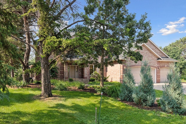 4301 Overlook Dr, Bloomington, MN 55437 - view of property hidden behind natural elements featuring brick siding, a front yard, driveway, and a garage