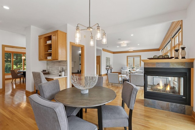 4301 Overlook Dr, Bloomington, MN 55437 - dining space with light wood-style floors, a multi sided fireplace, and recessed lighting