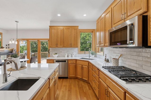 4301 Overlook Dr, Bloomington, MN 55437 - kitchen with stainless steel appliances, light wood-style flooring, recessed lighting, light stone countertops, and decorative backsplash