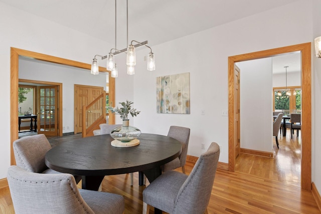 4301 Overlook Dr, Bloomington, MN 55437 - dining space featuring light wood-type flooring, stairs, and a chandelier