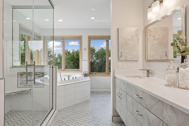 4301 Overlook Dr, Bloomington, MN 55437 - bathroom with vanity, a bath, a stall shower, and recessed lighting