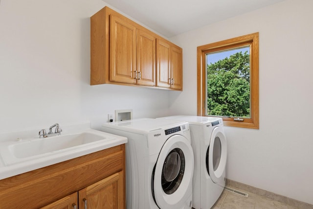 4301 Overlook Dr, Bloomington, MN 55437 - laundry room featuring cabinet space, washing machine and clothes dryer, and light tile patterned floors