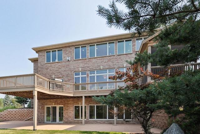 4301 Overlook Dr, Bloomington, MN 55437 - back of property featuring brick siding, a patio area, and a wooden deck