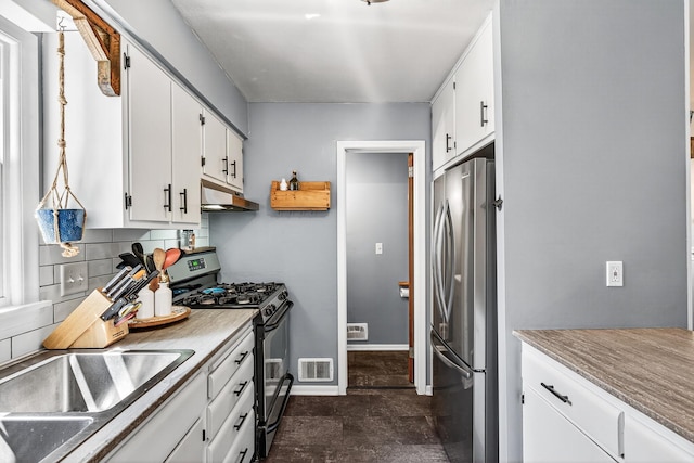 4309 78th Ave N, Brooklyn Park, MN 55443 - kitchen with appliances with stainless steel finishes, white cabinetry, backsplash, and under cabinet range hood