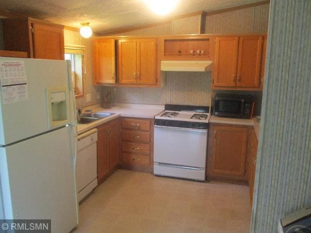 32546 360th St, Kimberly Twp, MN 56431 - kitchen with wallpapered walls, white appliances, light floors, light countertops, and premium range hood