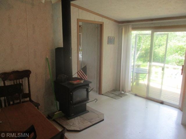 32546 360th St, Kimberly Twp, MN 56431 - living area with a wood stove, lofted ceiling, and crown molding