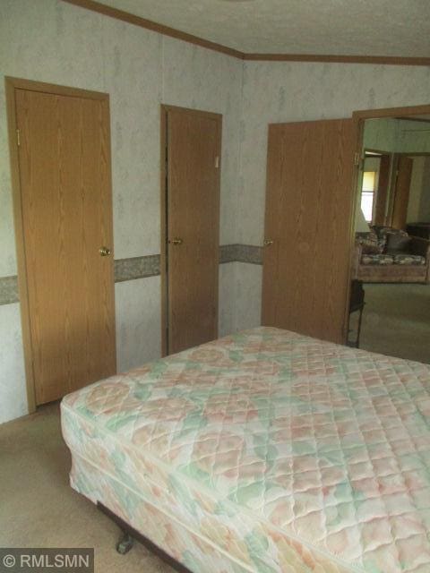 32546 360th St, Kimberly Twp, MN 56431 - bedroom featuring crown molding and wallpapered walls