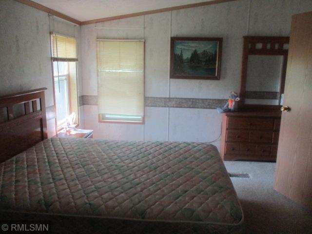 32546 360th St, Kimberly Twp, MN 56431 - bedroom with ornamental molding, carpet floors, and a wainscoted wall