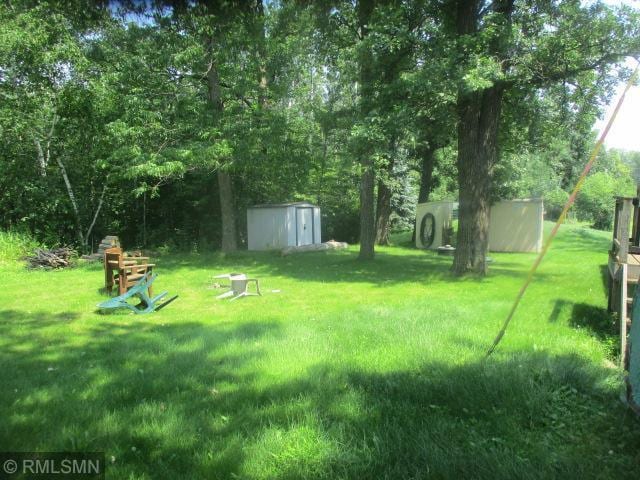 32546 360th St, Kimberly Twp, MN 56431 - view of green lawn with a storage unit