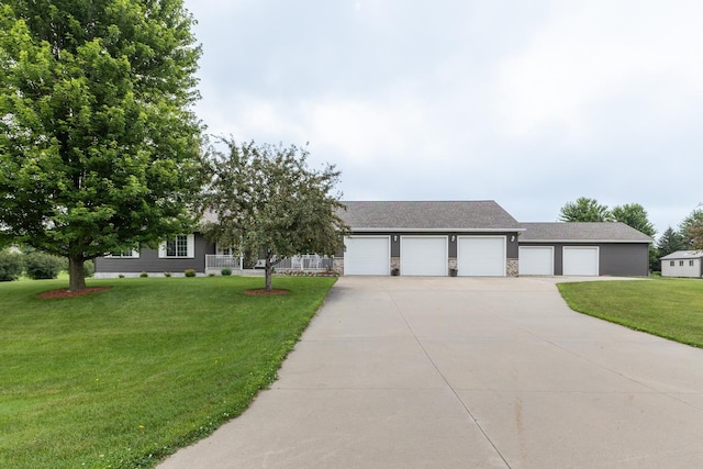 1902 11th Ave NE, Kasson, MN 55944 - view of front of home featuring a front yard, concrete driveway, a garage, roof with shingles, and stone siding