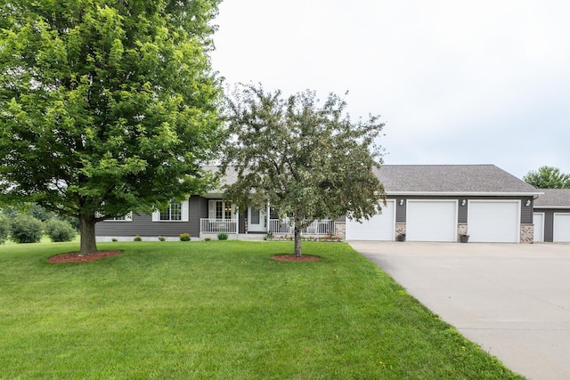 1902 11th Ave NE, Kasson, MN 55944 - view of front facade with concrete driveway, a front yard, covered porch, an attached garage, and stone siding