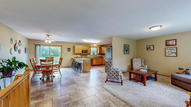 1902 11th Ave NE, Kasson, MN 55944 - living area featuring a ceiling fan and baseboards