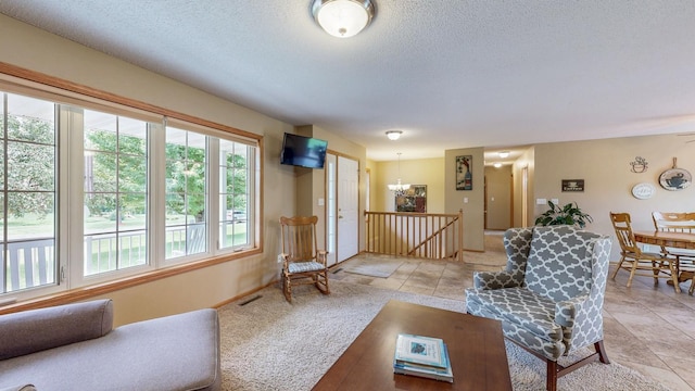 1902 11th Ave NE, Kasson, MN 55944 - living area with a textured ceiling and a chandelier
