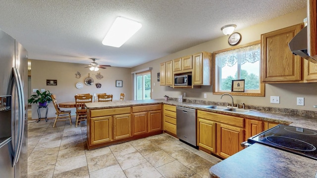 1902 11th Ave NE, Kasson, MN 55944 - kitchen featuring appliances with stainless steel finishes, a peninsula, a ceiling fan, a textured ceiling, and ventilation hood