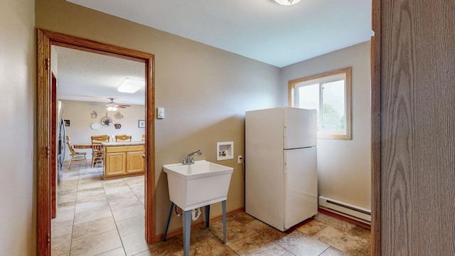 1902 11th Ave NE, Kasson, MN 55944 - kitchen with freestanding refrigerator and a baseboard radiator