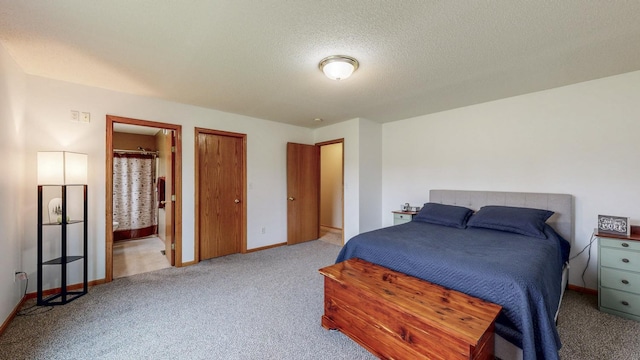 1902 11th Ave NE, Kasson, MN 55944 - bedroom featuring light carpet, a textured ceiling, and ensuite bath
