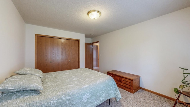 1902 11th Ave NE, Kasson, MN 55944 - carpeted bedroom featuring a closet and baseboards