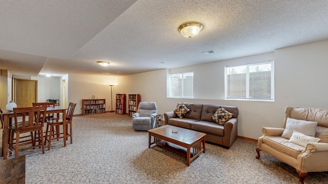 1902 11th Ave NE, Kasson, MN 55944 - carpeted living area featuring a textured ceiling and baseboards