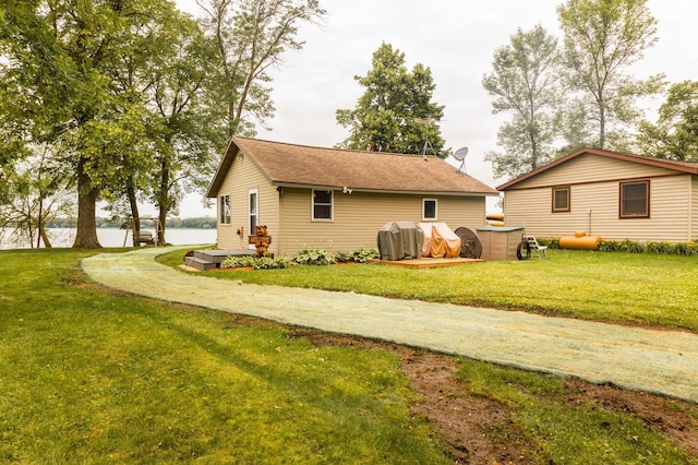 4236 Smith Lake Rd SE, Osakis, MN 56360 - view of property exterior with a yard, roof with shingles, and a water view