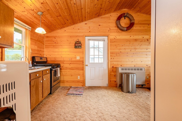 4236 Smith Lake Rd SE, Osakis, MN 56360 - kitchen with lofted ceiling, stainless steel range oven, light colored carpet, wooden walls, and brown cabinets