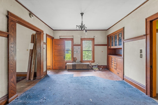2416 13th Ave S, Minneapolis, MN 55404 - empty room featuring radiator heating unit, ornamental molding, and a chandelier