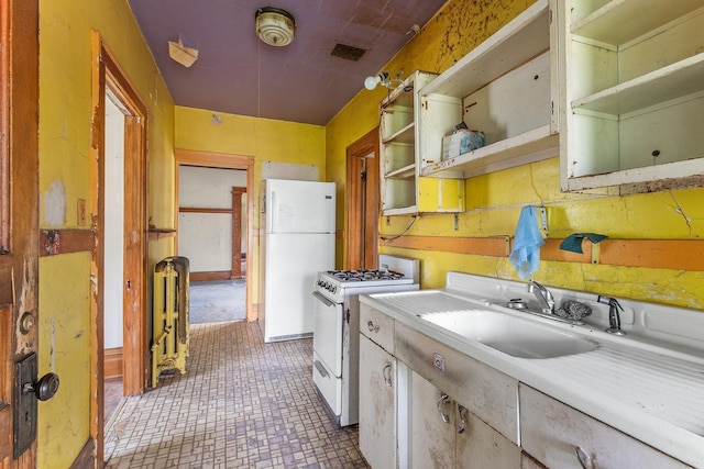 2416 13th Ave S, Minneapolis, MN 55404 - kitchen featuring white appliances, open shelves, light countertops, and radiator heating unit