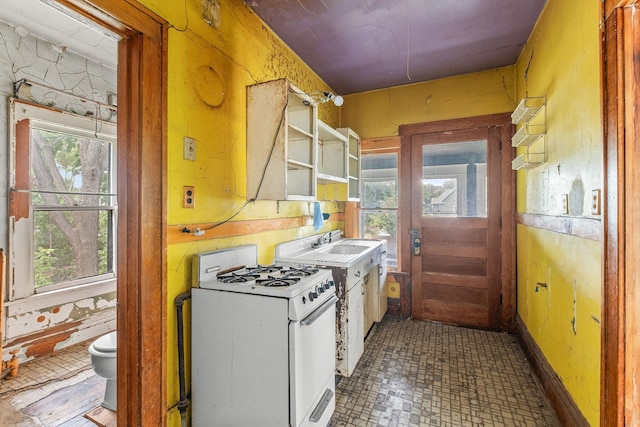 2416 13th Ave S, Minneapolis, MN 55404 - kitchen featuring white gas stove, plenty of natural light, and open shelves