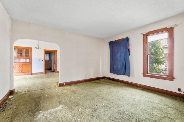 2416 13th Ave S, Minneapolis, MN 55404 - carpeted spare room with baseboards and arched walkways