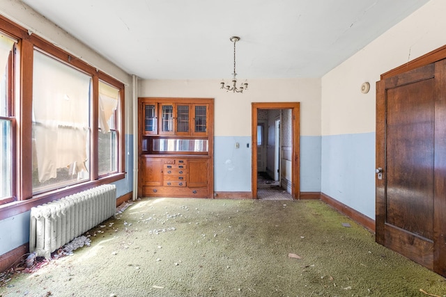 2416 13th Ave S, Minneapolis, MN 55404 - unfurnished dining area featuring radiator, carpet floors, and a chandelier