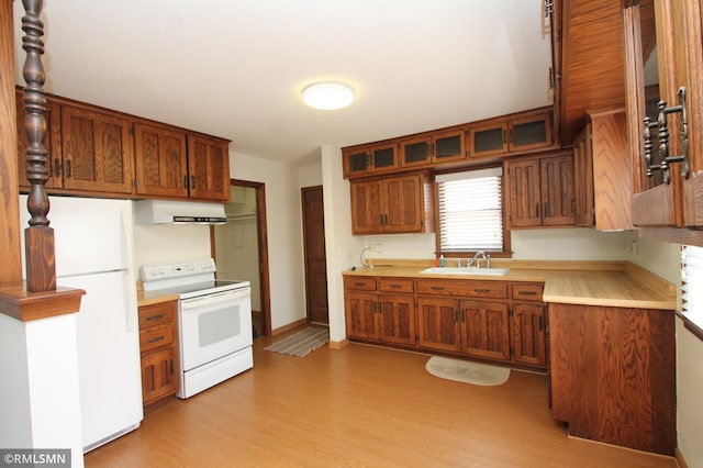 5327 53rd Ave N, Crystal, MN 55429 - kitchen featuring white appliances, light wood finished floors, light countertops, brown cabinetry, and glass insert cabinets
